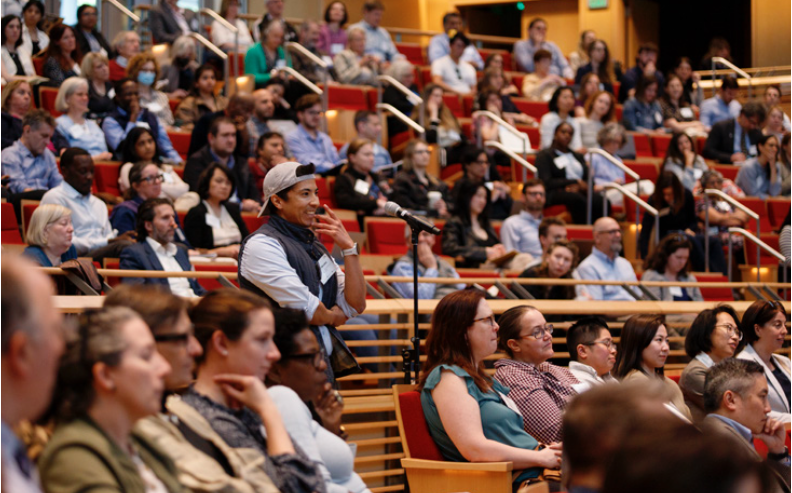 a person asking a question at a talk